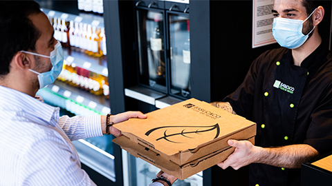 Photo de remise de pizzas au sein d'un restaurant Basilic & Co illustrant les bons résultats du premier semestre